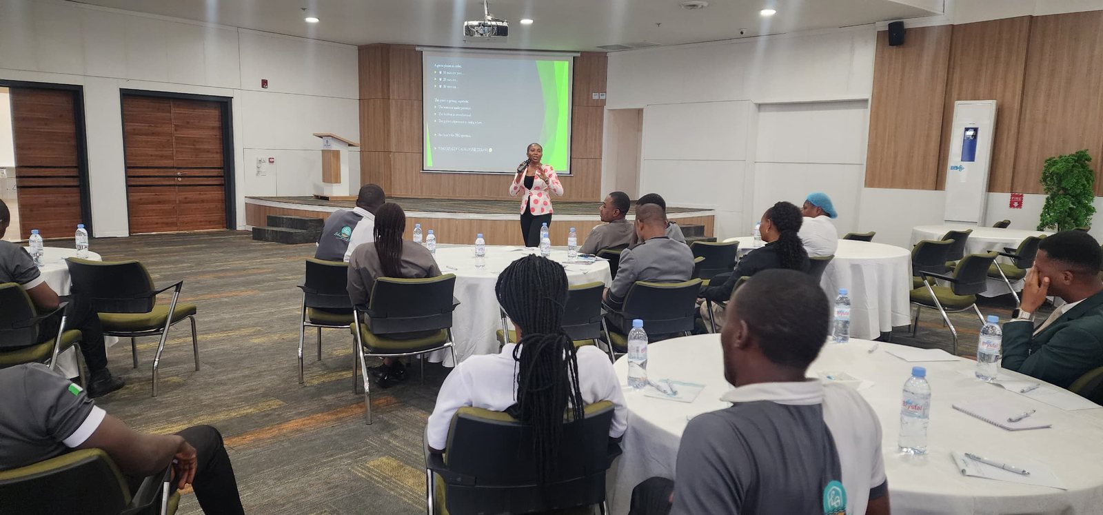 Mary Tom leading a training session for a hospitality team