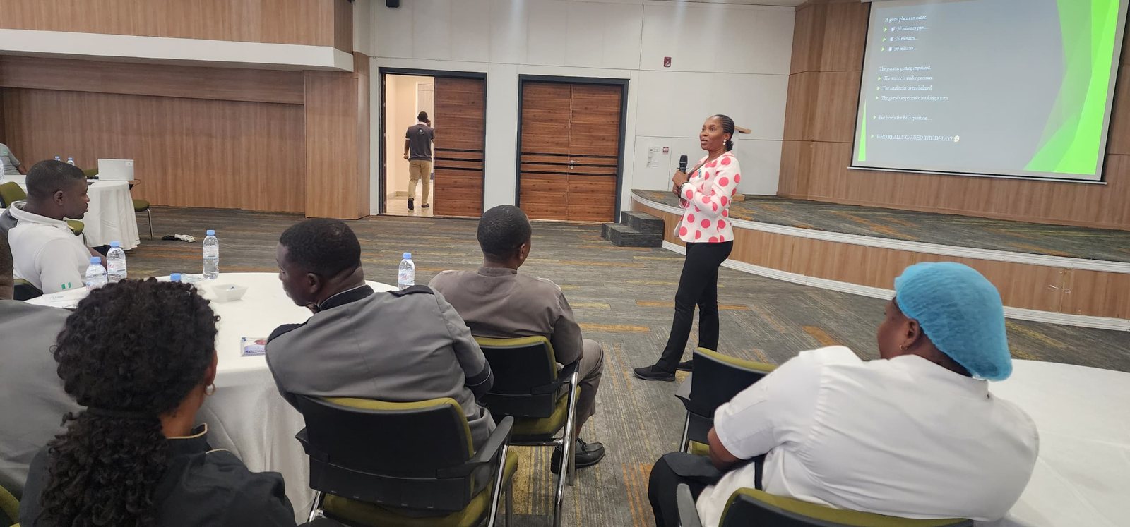 Mary Tom speaking to hospitality staff during a workshop